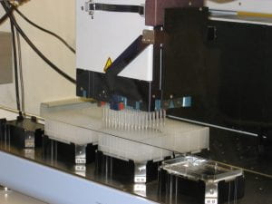 a photo of the MDT head with tips loaded, pipetting into large sample boxes