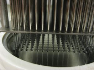 a photo of the pins of the pinning tool dipped into the sonicator