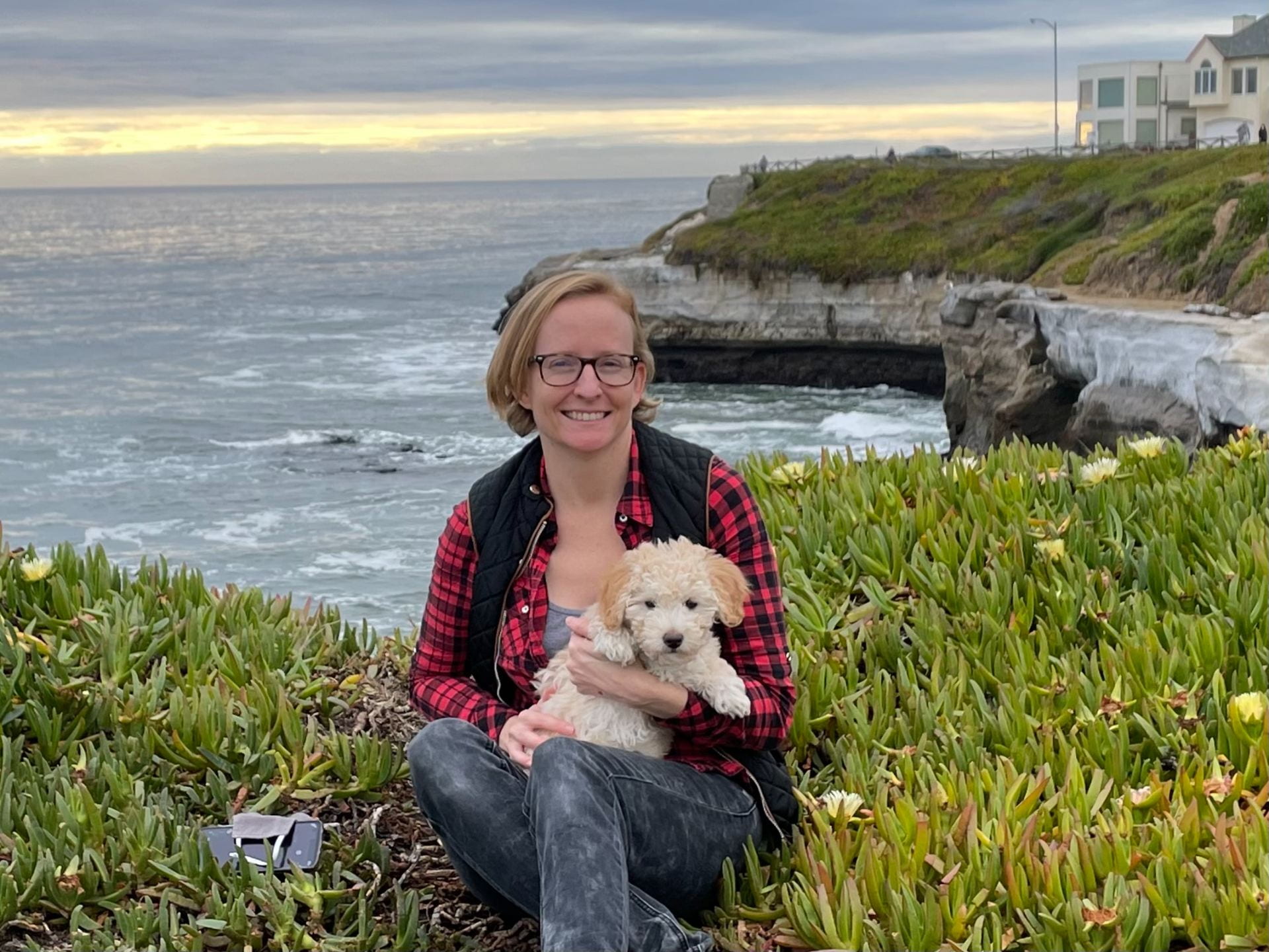 a photo of Beverley and her dog at the ocean in Santa Cruz