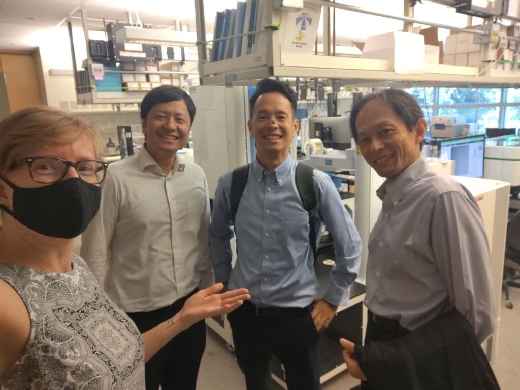 Beverley and three Ono Pharmaceutical guests standing in the CSC lab space